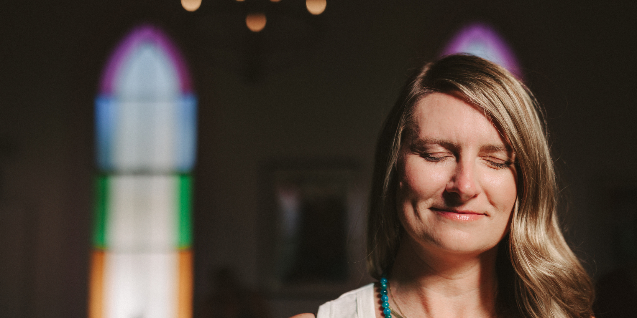 Woman with eyes closed in peaceful meditation at House of Bliss Yoga in Mason, Ohio